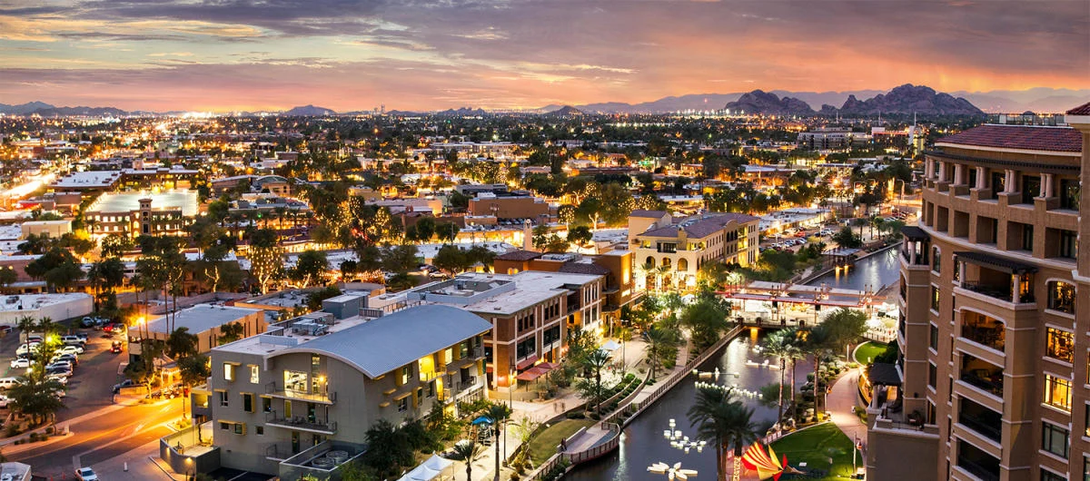 Residential Scottsdale neighborhood with palm-lined streets, desert landscaping, and upscale homes